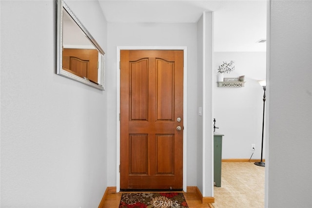 doorway to outside with baseboards