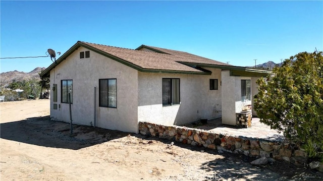 6613 Sunnyhill Rd, Joshua Tree, CA 92252 - rear view of house featuring stucco siding
