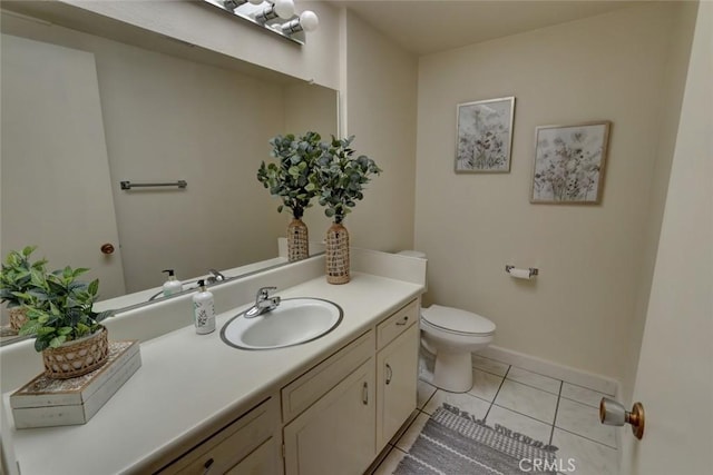 bathroom featuring tile patterned floors, toilet, vanity, and baseboards