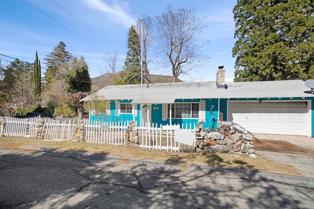 13954 Hazel Dr, Lytle Creek, CA 92358 - single story home with a fenced front yard, an attached garage, concrete driveway, and a chimney