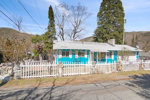 13954 Hazel Dr, Lytle Creek, CA 92358 - ranch-style home with a fenced front yard and a chimney