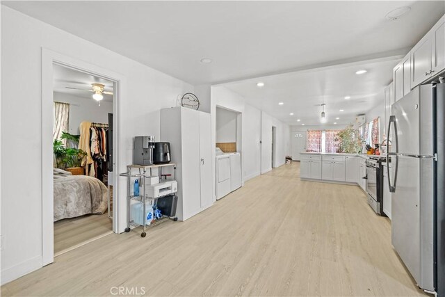 730 E 89th St, Los Angeles, CA 90002 - kitchen with light wood-type flooring, freestanding refrigerator, a peninsula, gas range, and washing machine and clothes dryer
