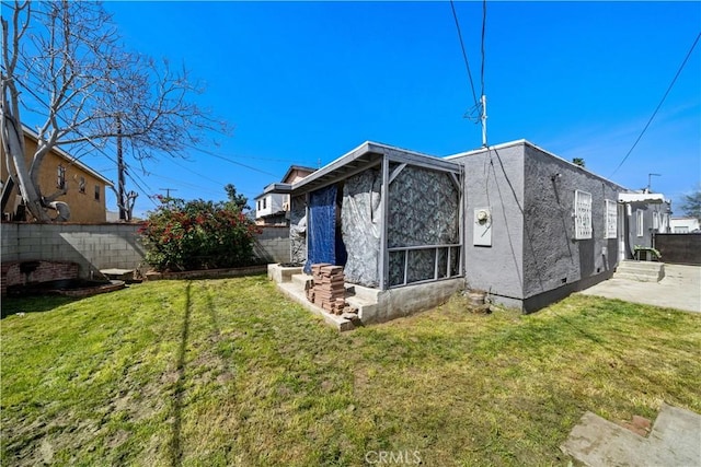 730 E 89th St, Los Angeles, CA 90002 - view of side of property with a yard, a patio, entry steps, and fence