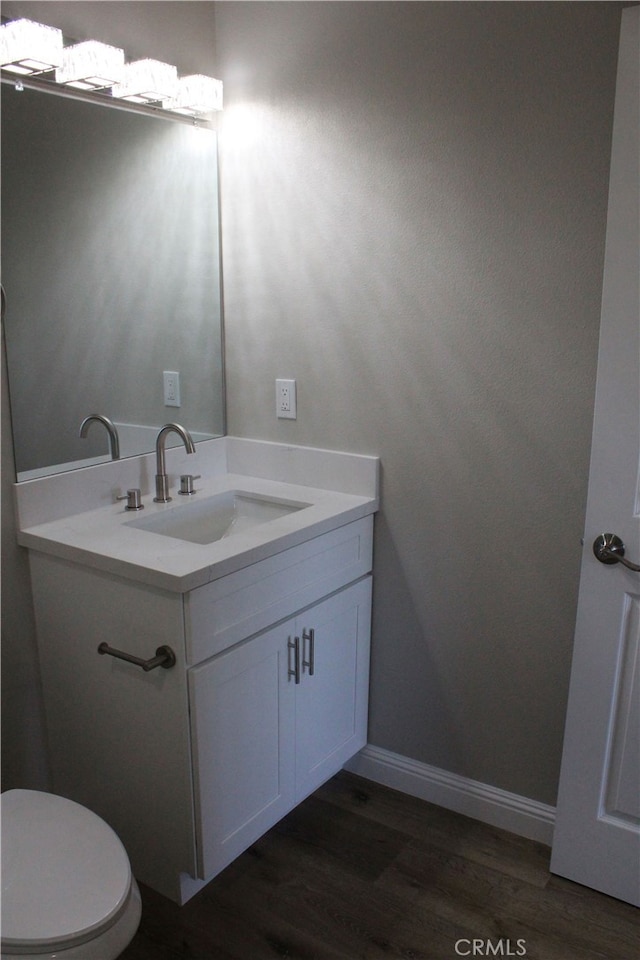 17730 Ivy Ave, Fontana, CA 92335 - bathroom with vanity, toilet, wood finished floors, and baseboards