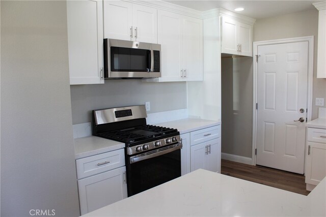 17730 Ivy Ave, Fontana, CA 92335 - kitchen with light countertops, white cabinets, dark wood-style flooring, and stainless steel appliances