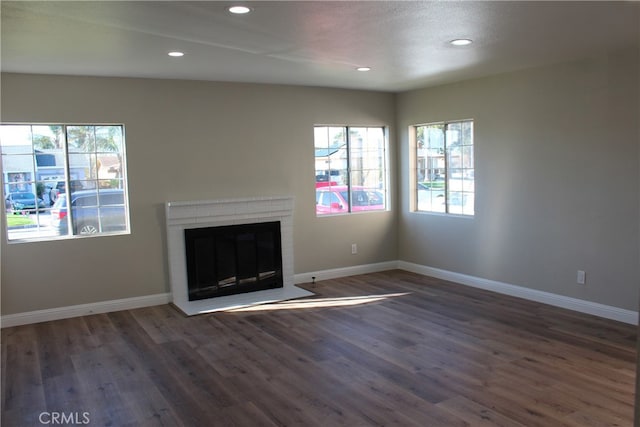 17730 Ivy Ave, Fontana, CA 92335 - unfurnished living room with baseboards, a brick fireplace, and wood finished floors