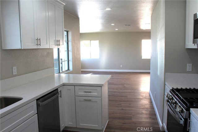 17730 Ivy Ave, Fontana, CA 92335 - kitchen featuring dark wood-style floors, dishwasher, a peninsula, and white cabinets