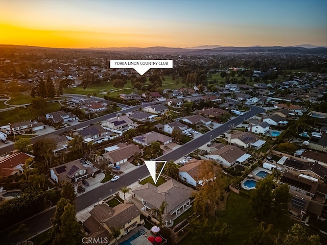 aerial view at dusk with a residential view and a mountain view