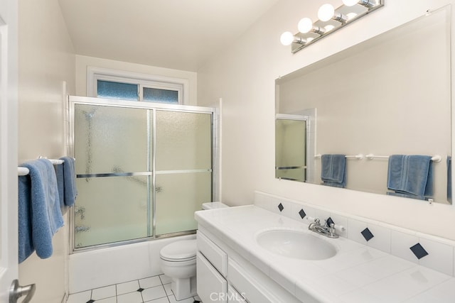 full bath featuring vanity, tile patterned flooring, enclosed tub / shower combo, and toilet