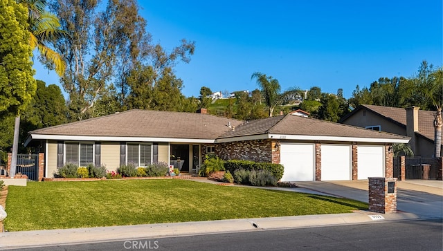 ranch-style house featuring a garage, a front lawn, fence, and concrete driveway