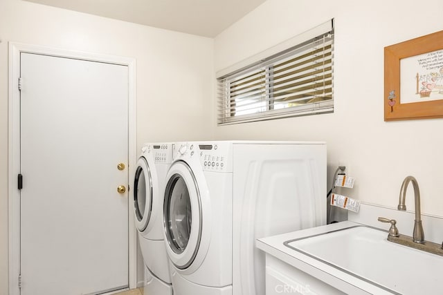 laundry room featuring independent washer and dryer, laundry area, and a sink