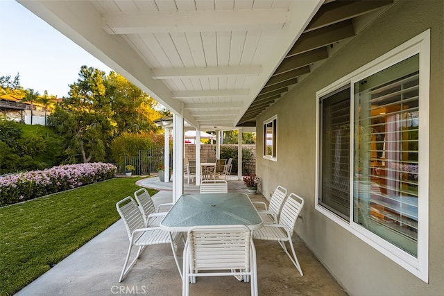 view of patio / terrace featuring outdoor dining area and fence
