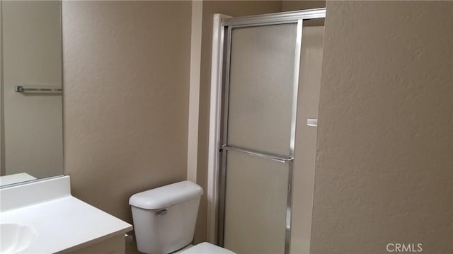 414 Nobel Ave Unit D, Santa Ana, CA 92707 - bathroom featuring a textured wall, vanity, a shower with door, and toilet