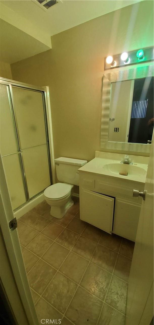 414 Nobel Ave Unit D, Santa Ana, CA 92707 - bathroom with vanity, toilet, a stall shower, and tile patterned flooring