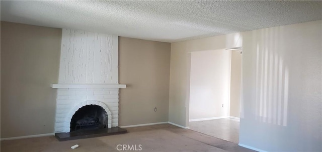 414 Nobel Ave Unit D, Santa Ana, CA 92707 - unfurnished living room with a fireplace, a textured ceiling, and baseboards