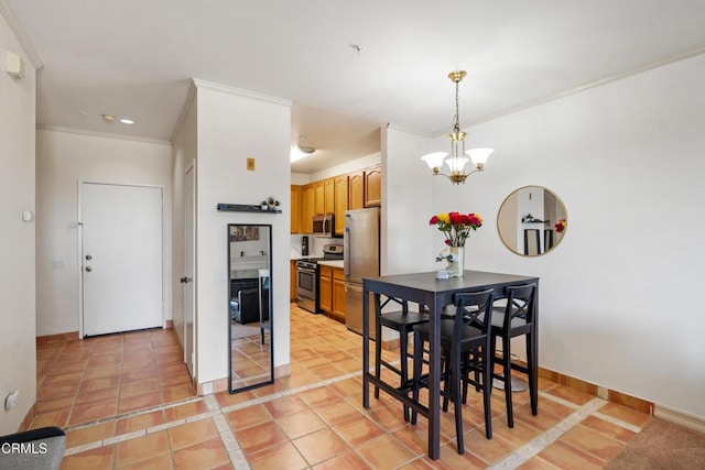 dining area with ornamental molding, baseboards, light tile patterned floors, and a chandelier