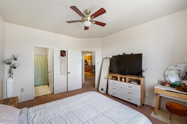 carpeted bedroom featuring freestanding refrigerator and a ceiling fan