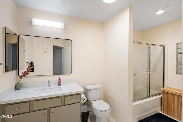full bathroom with vanity, toilet, and bath / shower combo with glass door
