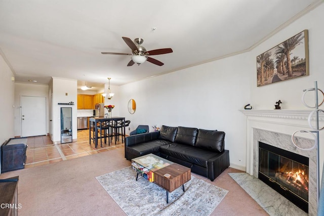 living room featuring ornamental molding, light tile patterned floors, a premium fireplace, light colored carpet, and ceiling fan