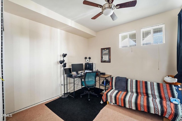 carpeted office space with a ceiling fan