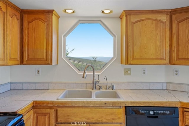 kitchen with range, recessed lighting, black dishwasher, tile countertops, and a sink
