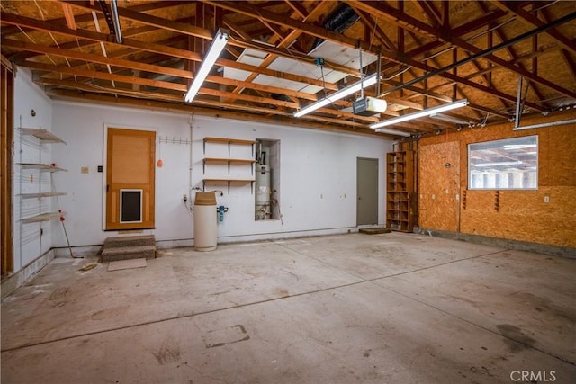 garage with secured water heater and a garage door opener