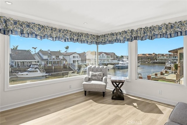 16449 Ladona Cir, Huntington Beach, CA 92649 - living area featuring wood finished floors, a water view, baseboards, recessed lighting, and ornamental molding