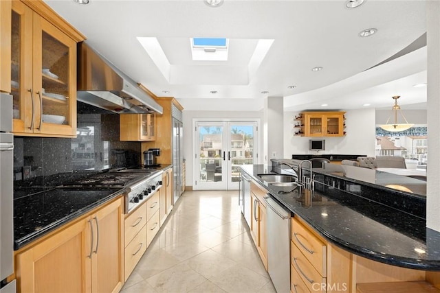 16449 Ladona Cir, Huntington Beach, CA 92649 - kitchen with a sink, a raised ceiling, decorative backsplash, appliances with stainless steel finishes, and wall chimney exhaust hood
