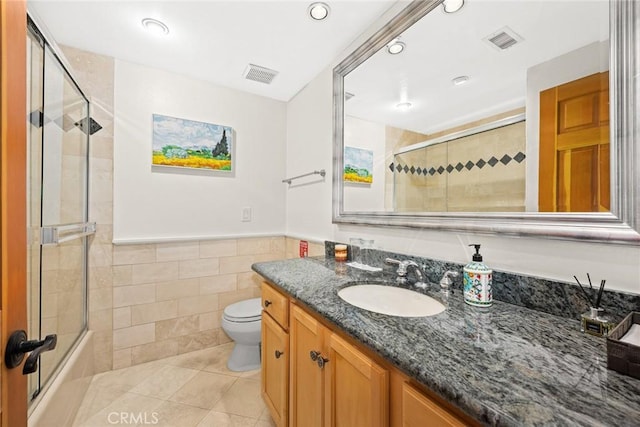 16449 Ladona Cir, Huntington Beach, CA 92649 - full bath with tile walls, toilet, vanity, tile patterned flooring, and a wainscoted wall