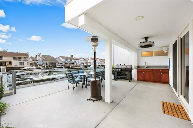 16449 Ladona Cir, Huntington Beach, CA 92649 - view of patio featuring a sink, grilling area, a residential view, and outdoor dining space
