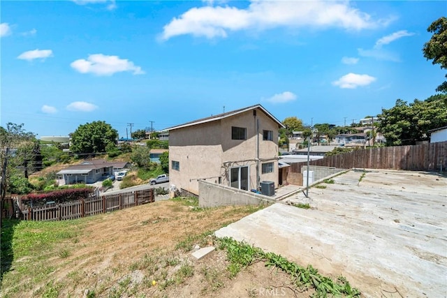 1116 Herbert Ave, Los Angeles, CA 90063 - rear view of property featuring a fenced backyard, a patio, stucco siding, and central AC