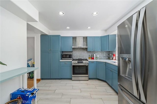 1116 Herbert Ave, Los Angeles, CA 90063 - kitchen featuring stainless steel appliances, wall chimney exhaust hood, blue cabinets, and recessed lighting