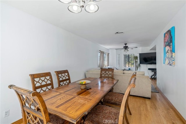 1116 Herbert Ave, Los Angeles, CA 90063 - dining area featuring light wood-style floors, ceiling fan, a chandelier, and baseboards