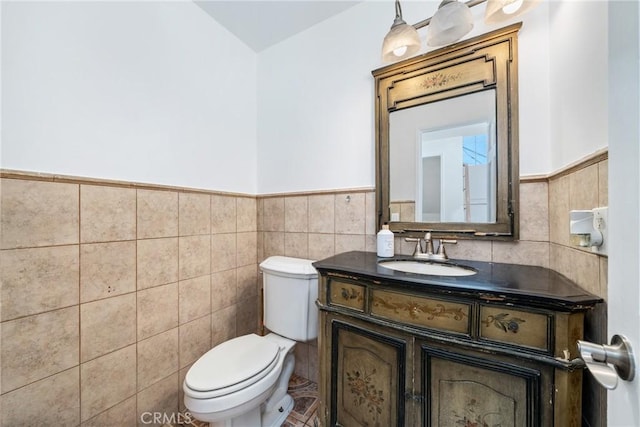 1116 Herbert Ave, Los Angeles, CA 90063 - half bathroom with tile walls, a wainscoted wall, toilet, and vanity