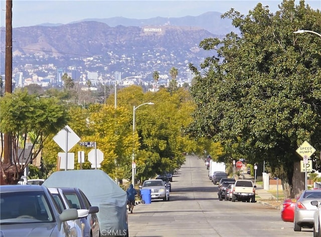 view of road featuring traffic signs and a mountain view
