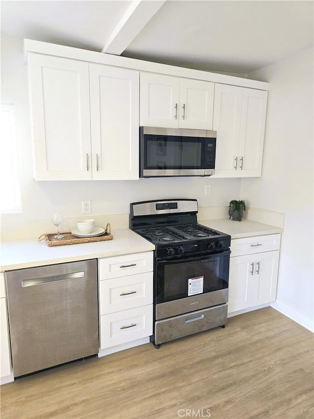 kitchen featuring light wood-style floors, appliances with stainless steel finishes, and white cabinets