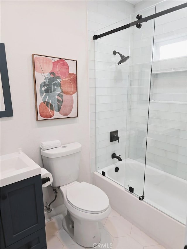 bathroom featuring vanity, tile patterned floors, toilet, and shower / bath combination with glass door