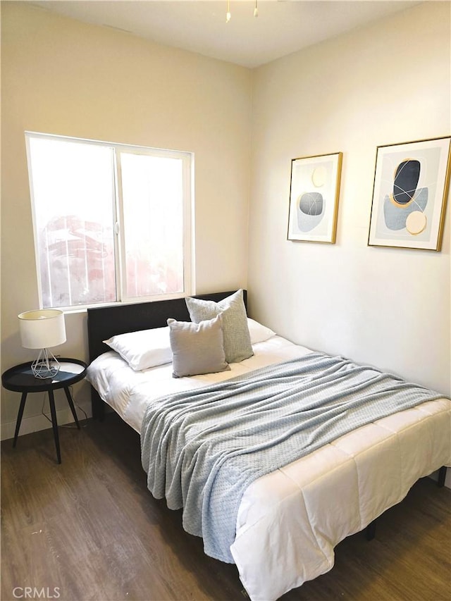 bedroom featuring wood finished floors
