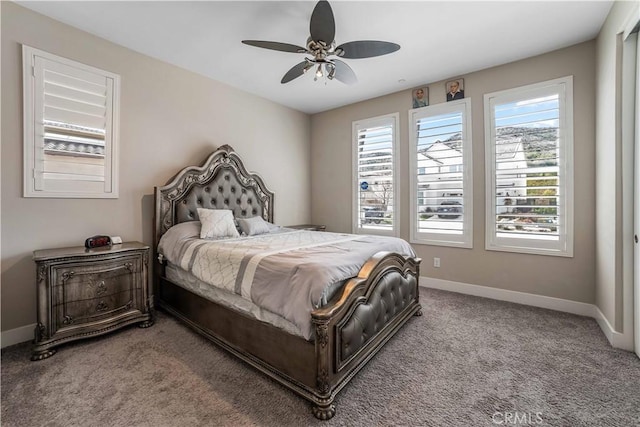bedroom with light colored carpet, ceiling fan, and baseboards