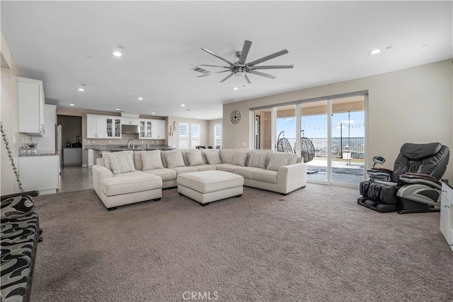 living area featuring visible vents, light colored carpet, recessed lighting, and ceiling fan