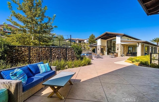 view of patio featuring outdoor lounge area and fence