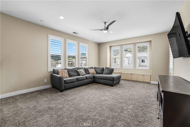 living area with ceiling fan, baseboards, visible vents, and carpet