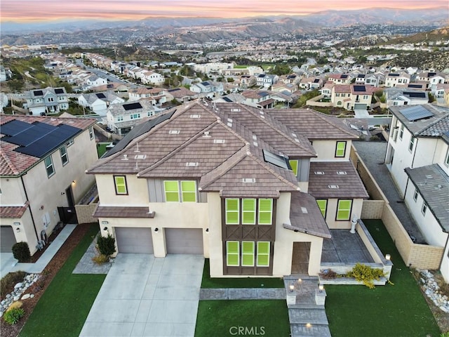 aerial view at dusk with a mountain view and a residential view
