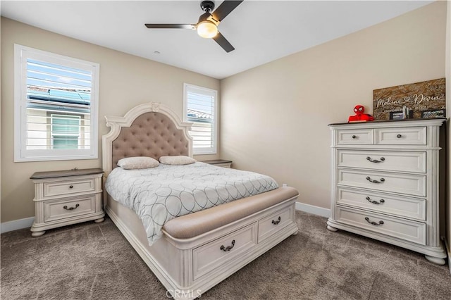 bedroom with dark colored carpet, baseboards, and ceiling fan