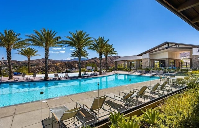 community pool featuring a patio and a mountain view