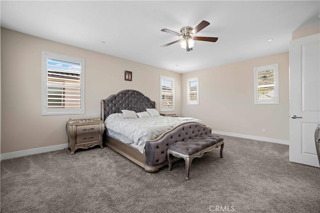 bedroom with ceiling fan, carpet floors, baseboards, and multiple windows