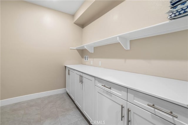 bar featuring light tile patterned flooring and baseboards