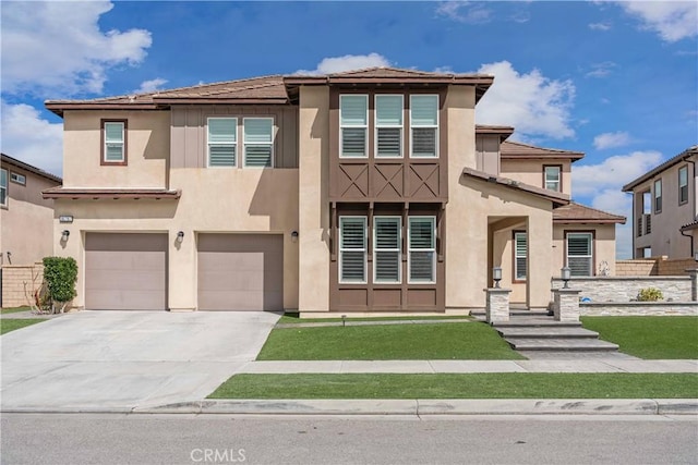 view of front of house with an attached garage, driveway, a front lawn, and stucco siding