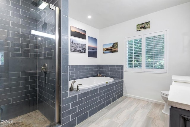 bathroom featuring vanity, a garden tub, toilet, and a shower stall