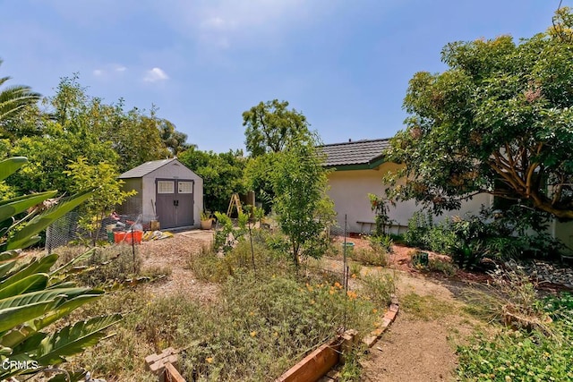 view of yard with a storage shed and an outdoor structure